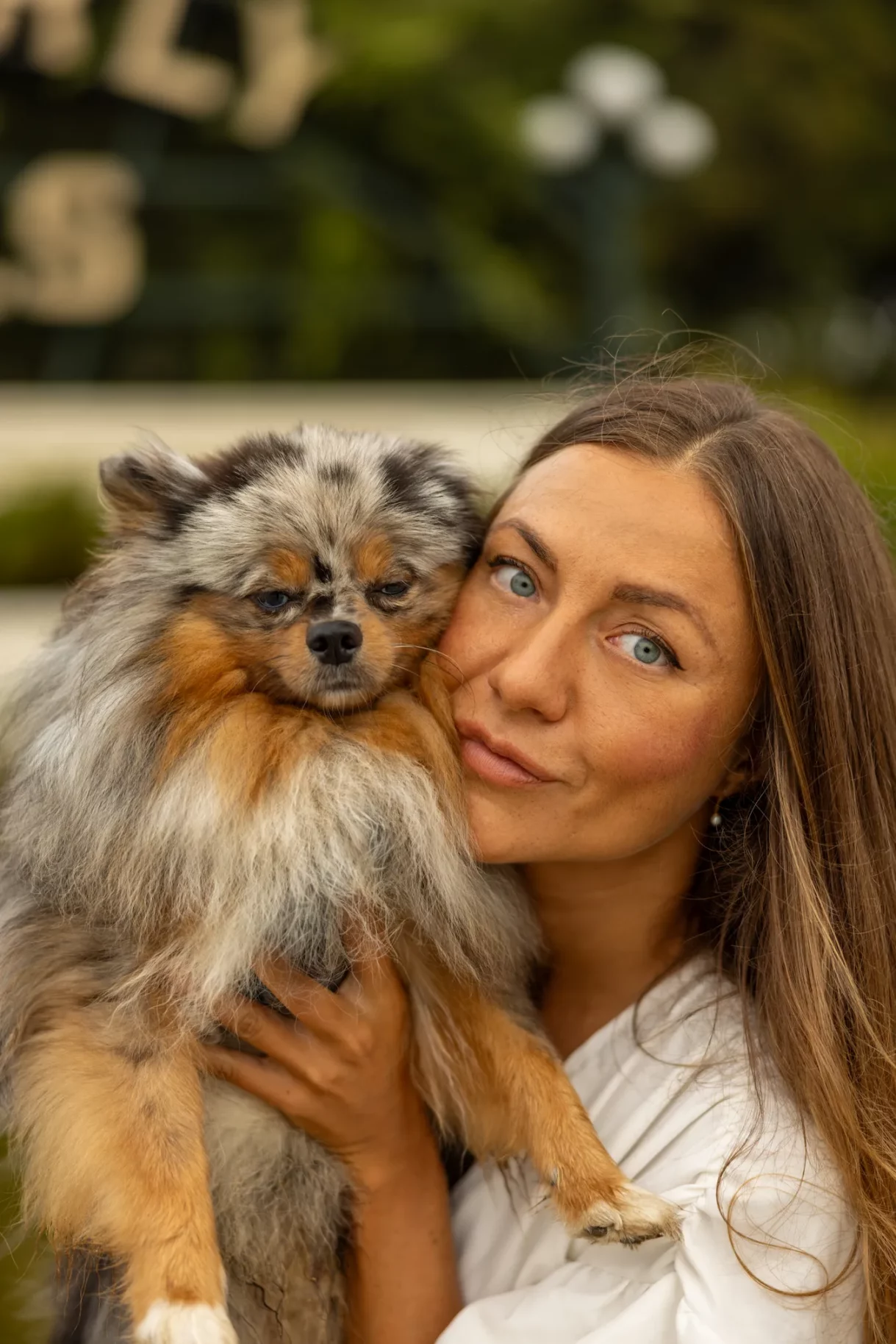 Woman holding her Pomeranian close in Beverly Hills