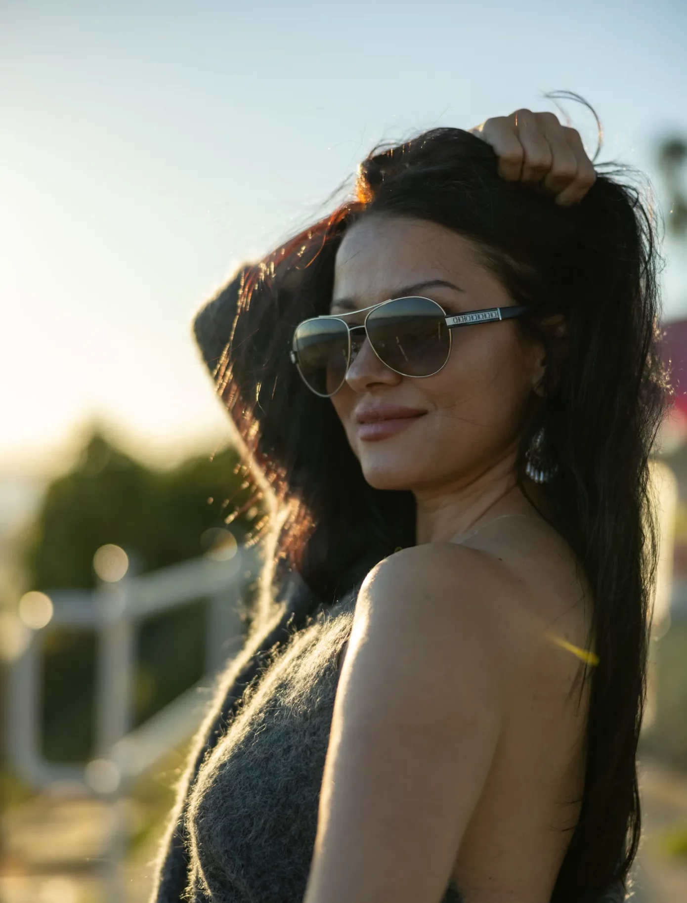 Confident woman in sunglasses with intense look at Bluff Park, Long Beach, Los Angeles