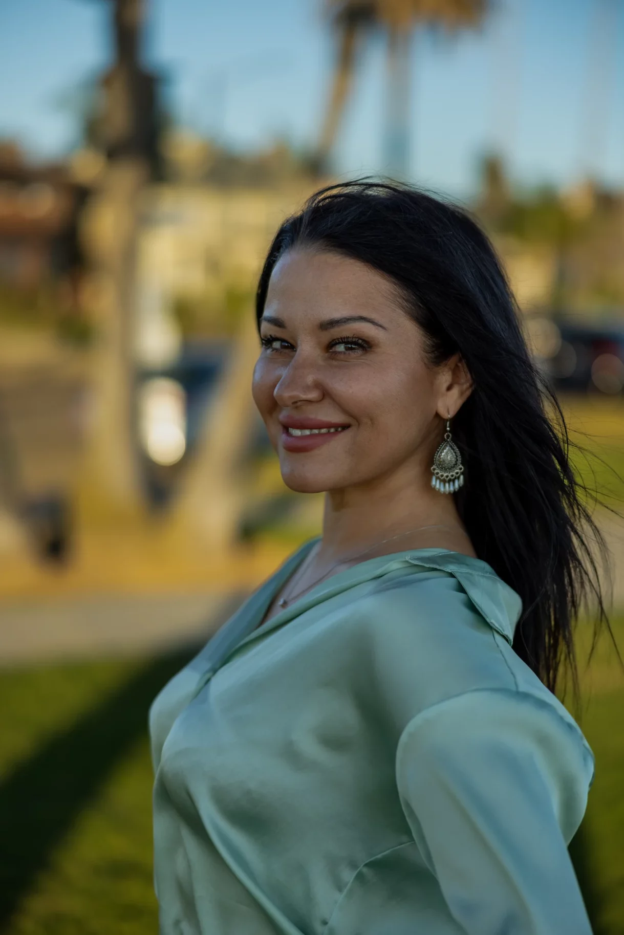 Woman in elegant blouse smiling in Bluff Park, Long Beach, Los Angeles