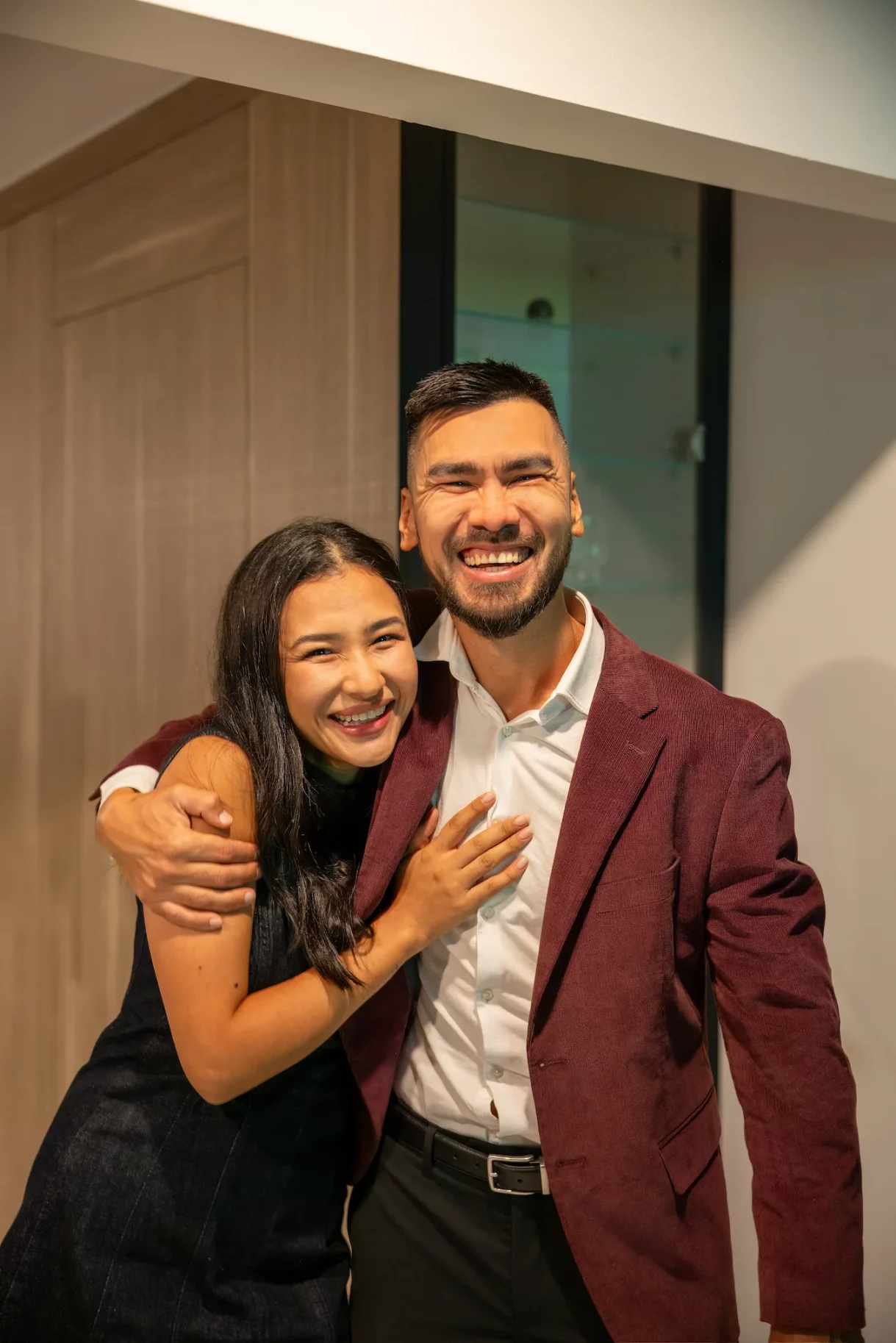 Birthday host joyfully embracing a friend at Beverly Hills celebration