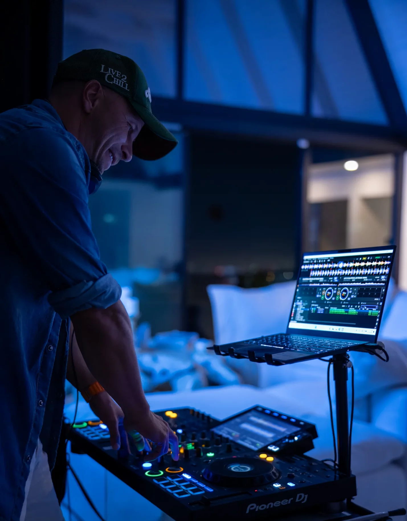 DJ mixing tracks on his deck at a lively Beverly Hills birthday party.