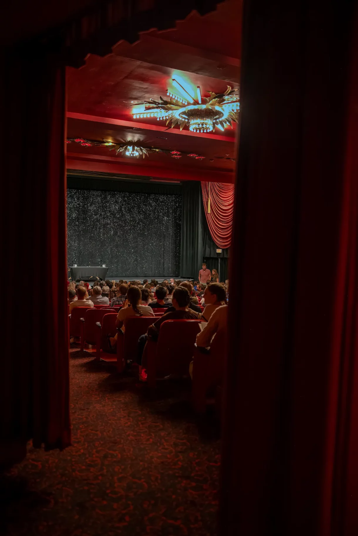 Entrance view into the theater hall as guests begin gathering for the lecture at the Fine Arts Theater in Beverly Hills.