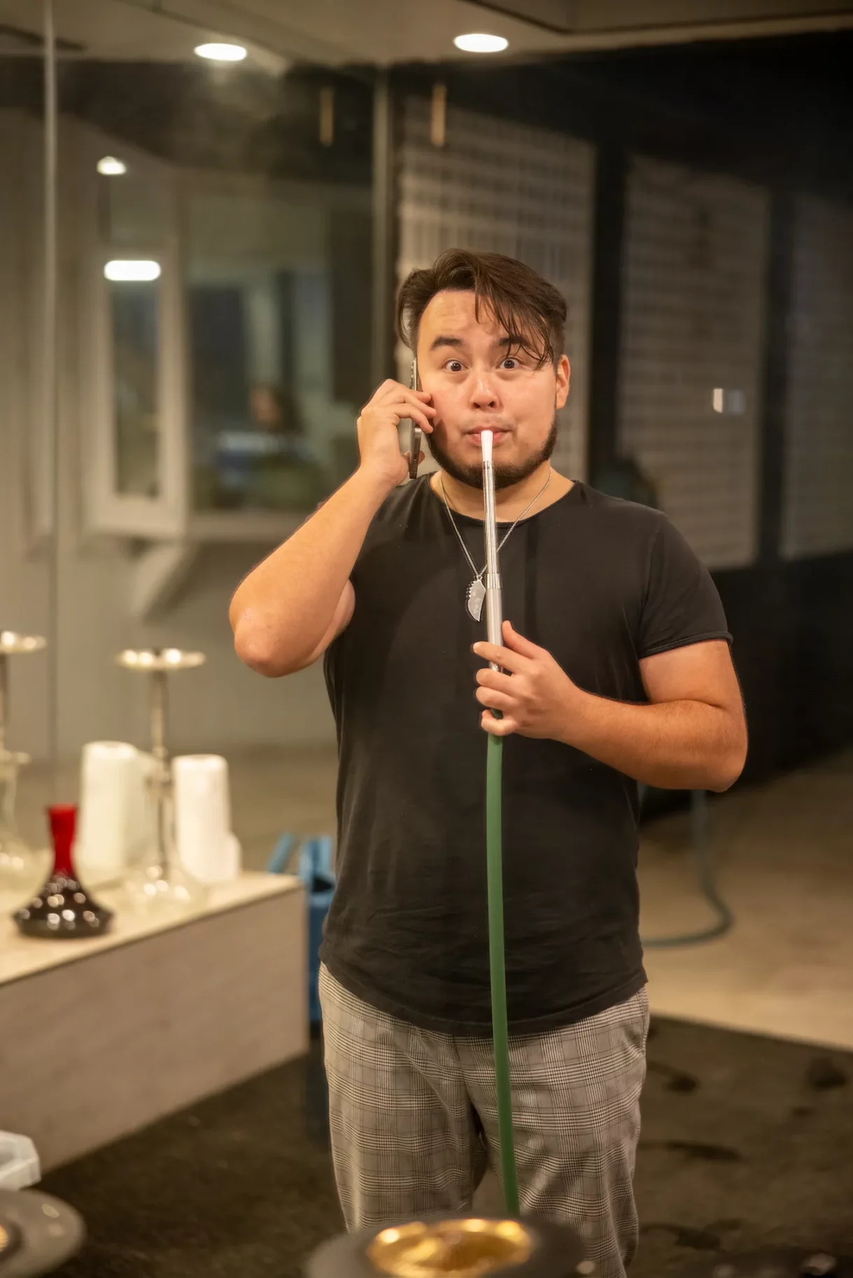 Hookah specialist preparing a shisha while on a phone call at Beverly Hills birthday celebration.