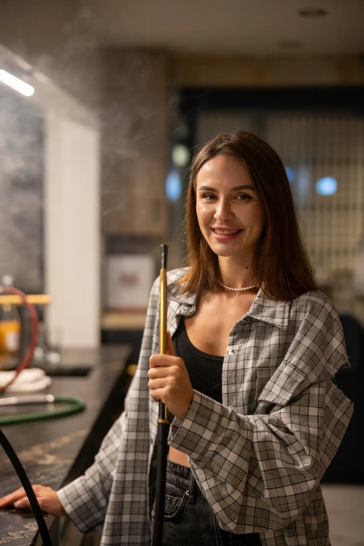 Young woman holding a hookah during a Beverly Hills birthday celebration.